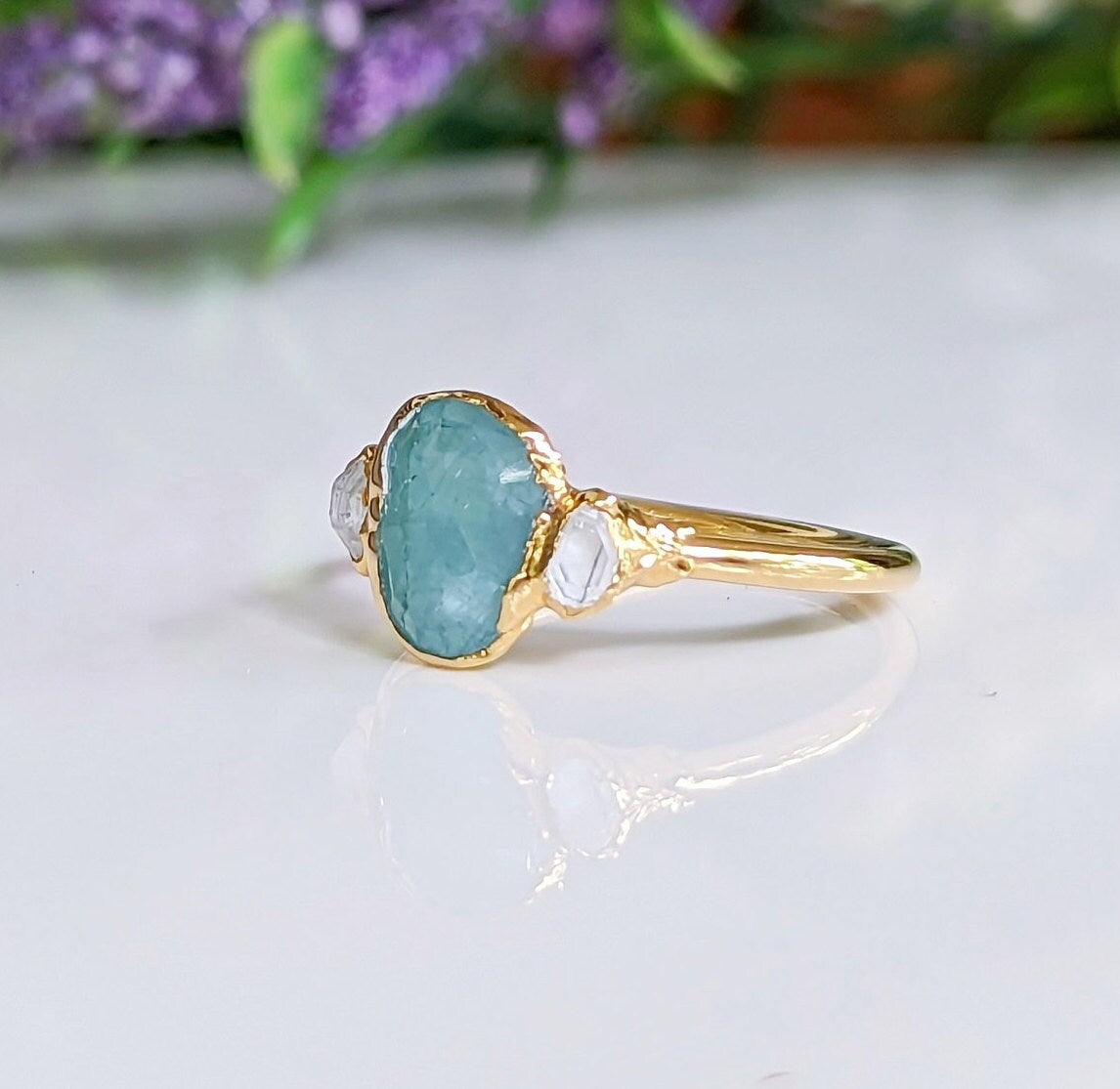 Aqua blue Grandidierite and diamond ring set in 18k gold, showcasing its unique beauty and craftsmanship.