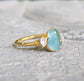 Aqua blue Grandidierite ring with Herkimer diamonds, set in 18k gold, showcasing unique craftsmanship.