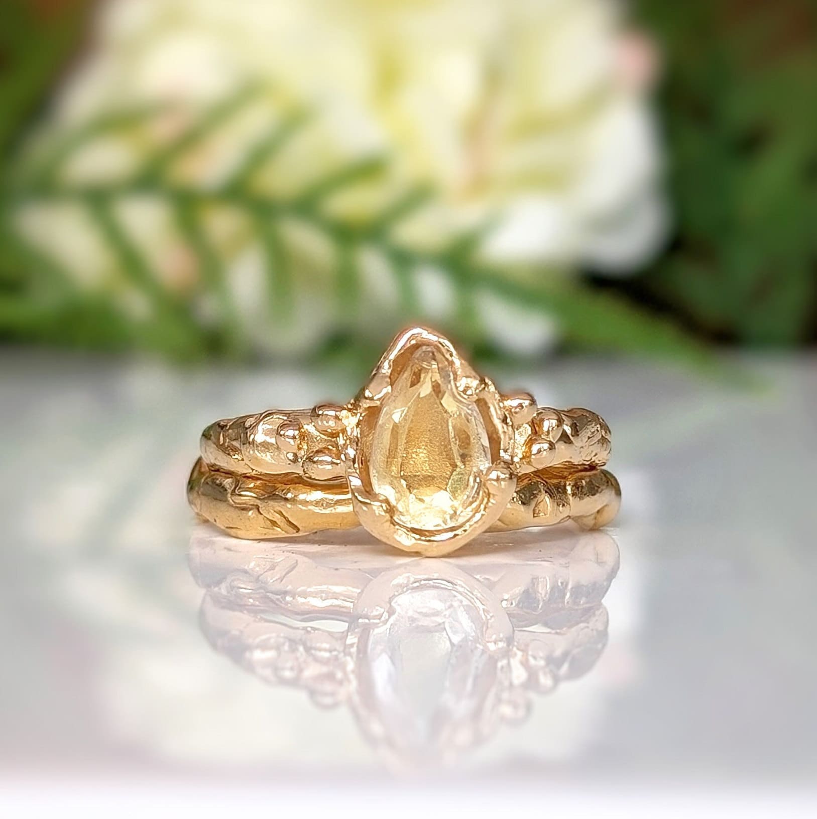 Handcrafted solid 14k gold ring featuring a pear-shaped citrine gemstone on an organic textured band.