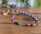 Handcrafted Multi Tourmaline bead necklace featuring vibrant colors and unique hues on a wooden background.