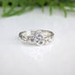 Handcrafted sterling silver CZ cluster ring with three cubic zirconia stones, showcasing elegance and brilliance.