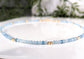 Handmade aquamarine bead necklace featuring soft blue gemstones and gold accents, symbolizing calmness and loyalty.