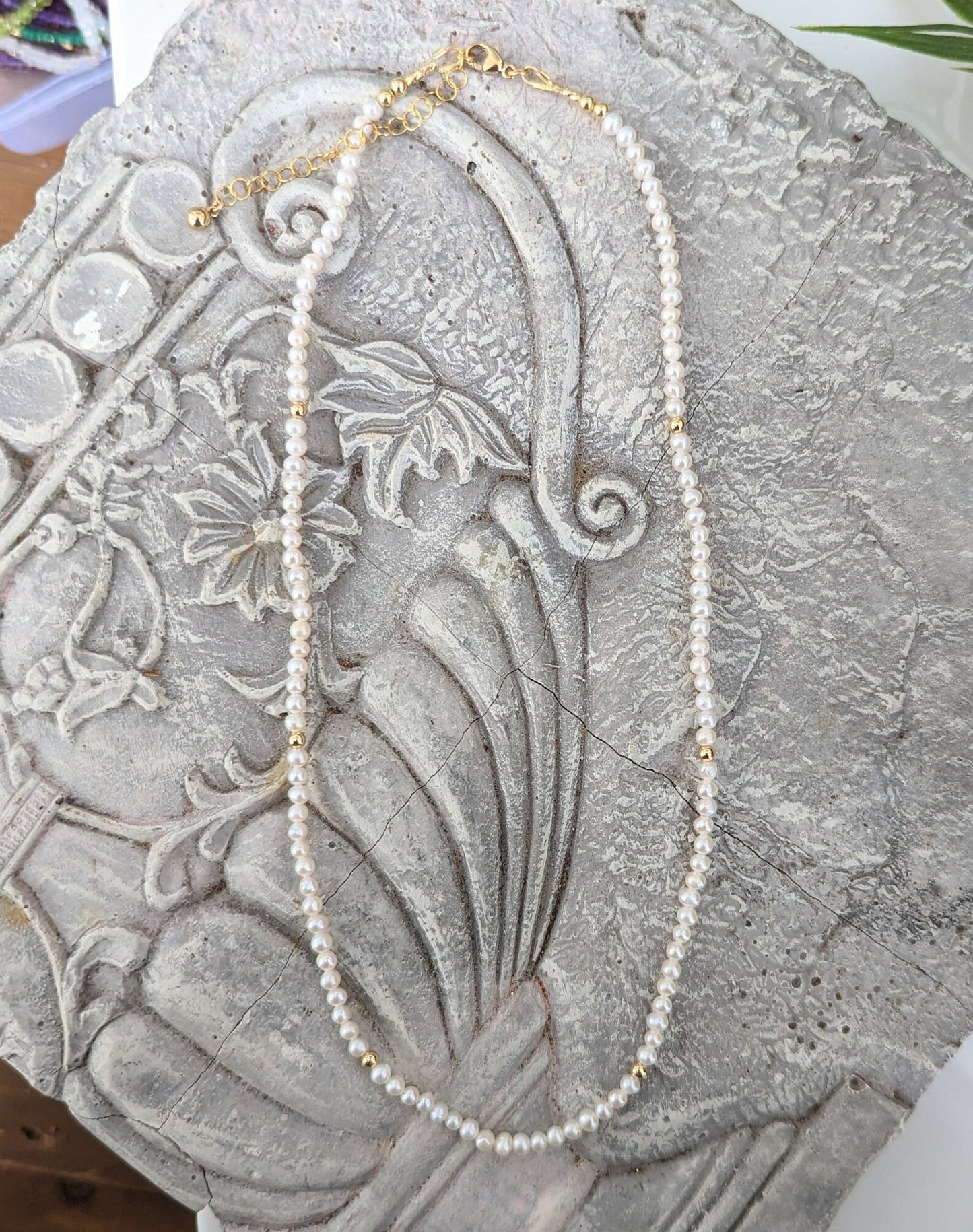 Delicate freshwater pearl necklace with gold accents, perfect for weddings or as a Mother's Day gift.