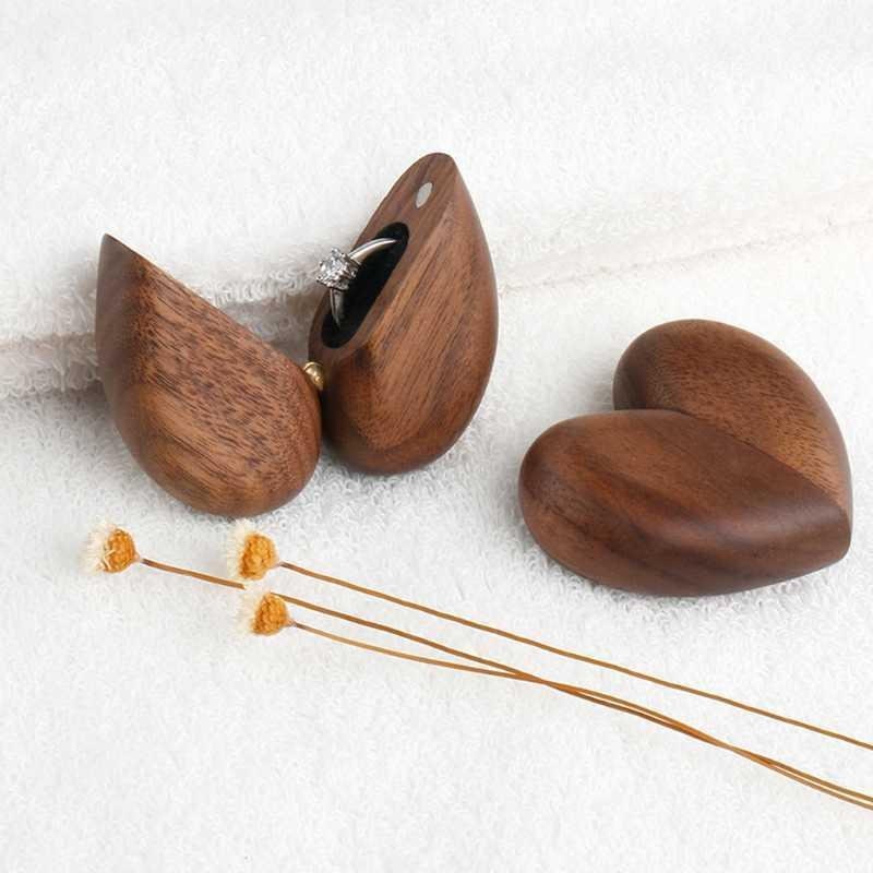 Heart-shaped wooden engagement ring box with a ring inside, perfect for gifting jewelry.