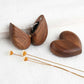 Heart-shaped wooden engagement ring box with a ring inside, perfect for gifting jewelry.