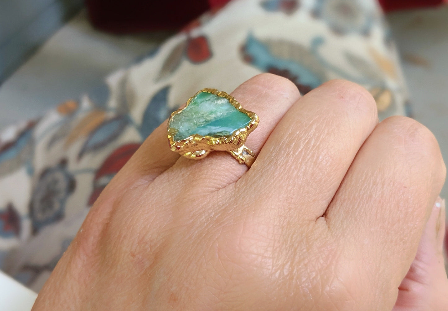 Handcrafted raw Peruvian opal ring with aqua blue stone on a 14k gold filled band, elegantly displayed on a hand.