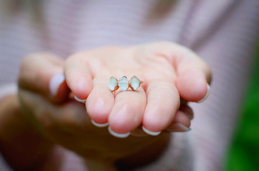 Handcrafted triple Herkimer diamond ring showcased on a hand, featuring three raw quartz crystals in a 14k gold band.