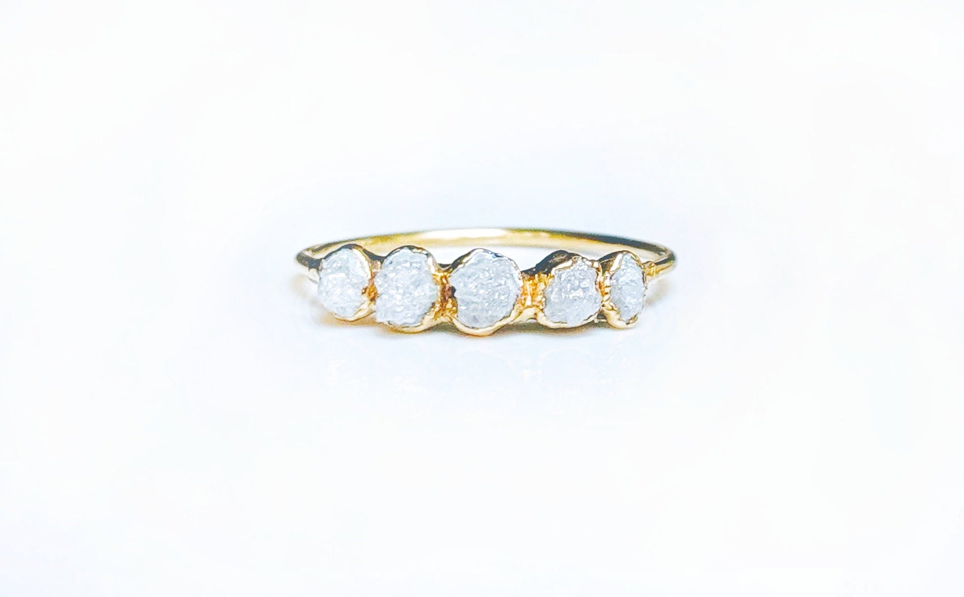 Raw diamond Eternity ring in 18k Gold setting showcasing five conflict-free uncut diamonds.