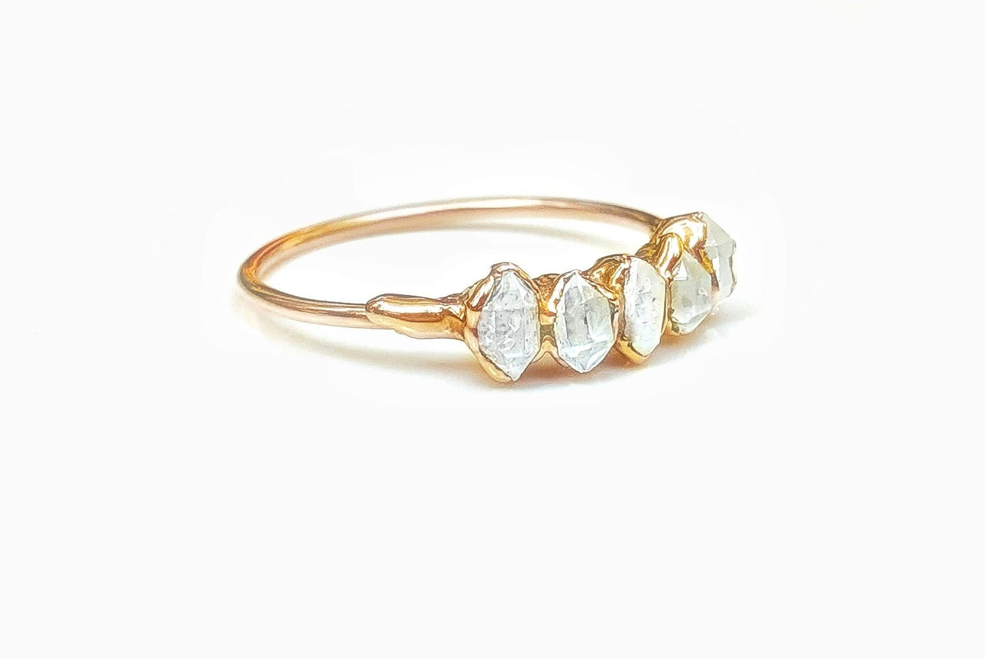 Handcrafted Silver Eternity ring featuring five raw Herkimer diamonds on a delicate band, showcasing unique gemstone shapes.