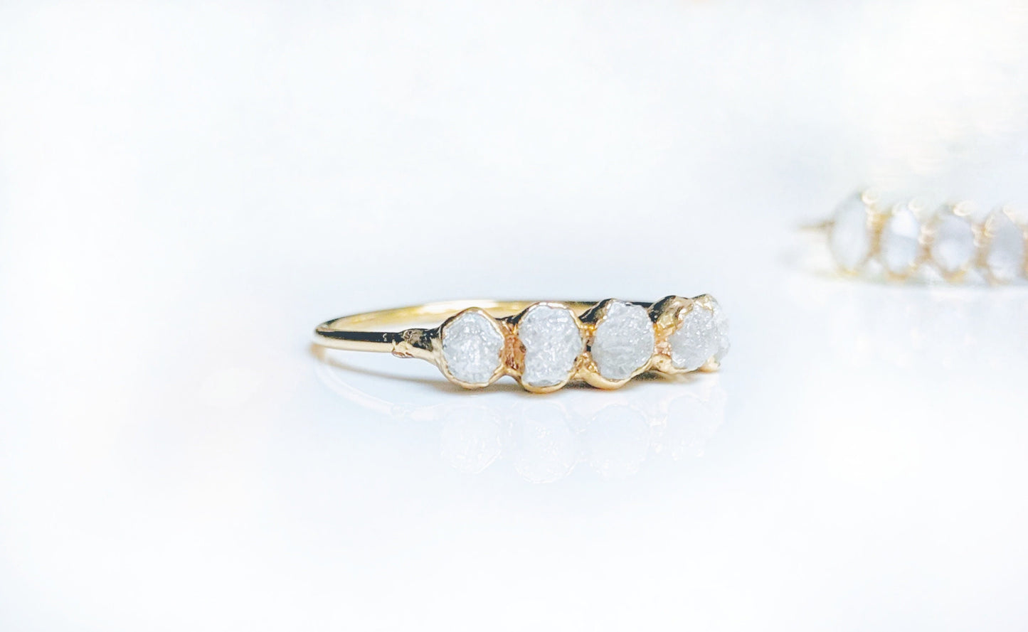 Raw diamond eternity ring in 14k gold with five conflict-free raw diamonds, symbolizing everlasting love.
