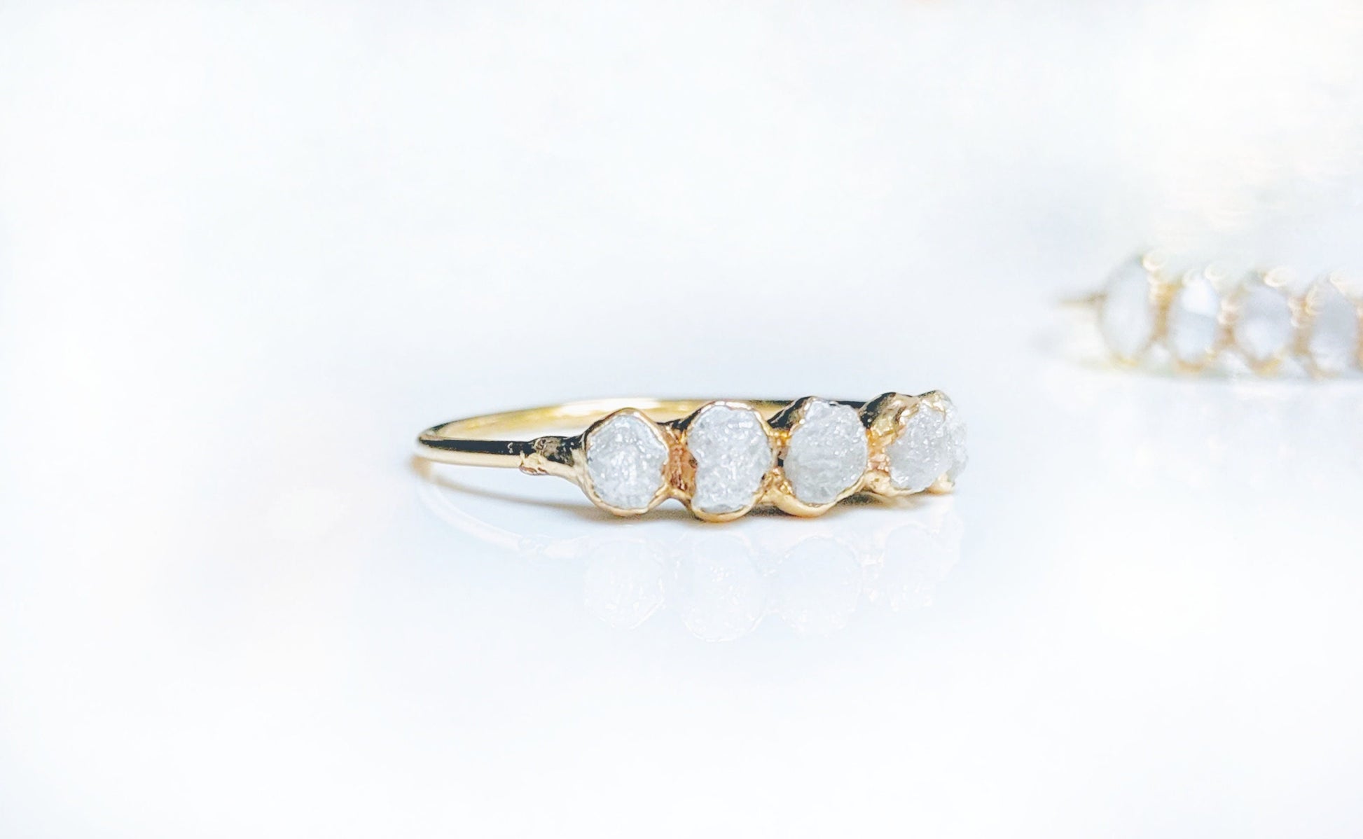 Raw diamond eternity ring in 14k gold with five conflict-free raw diamonds, symbolizing everlasting love.