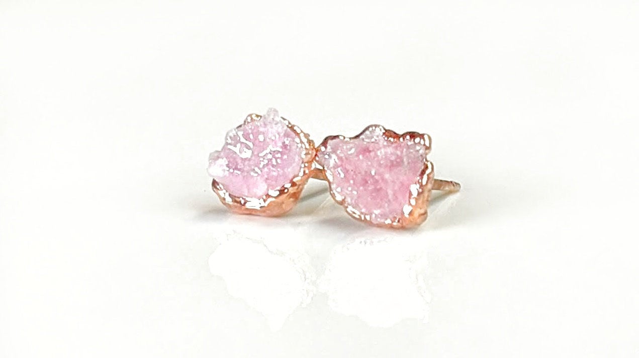 Raw Rose Quartz stud earrings on rose gold posts, promoting self-love and happiness with a soft, gentle energy.