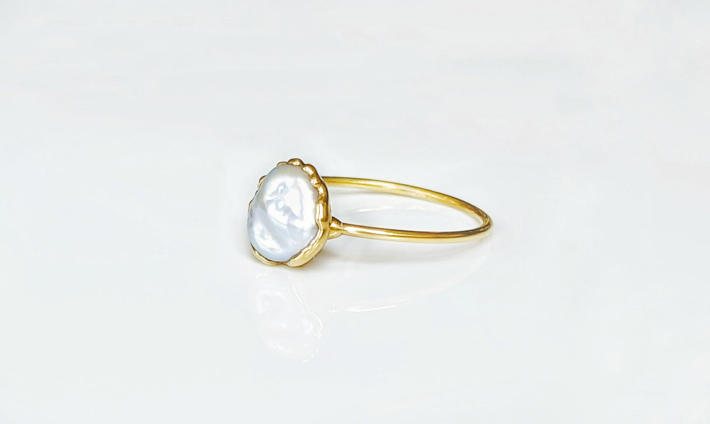 Small Freshwater Keshi pearl ring on a 14k Gold band showcasing subtle elegance and simplicity.