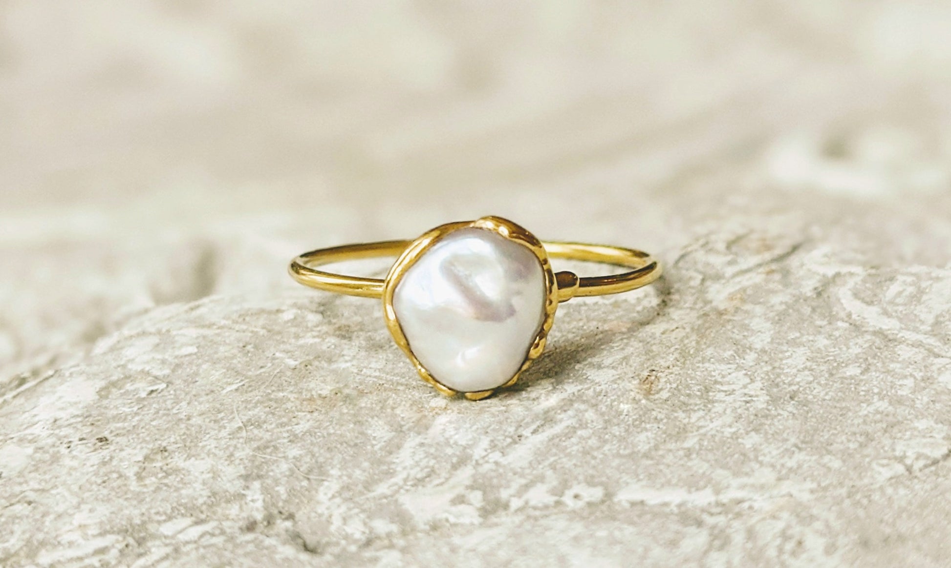 Small freshwater Keshi pearl ring on solid 14k gold band, showcasing simple elegance and handcrafted beauty.