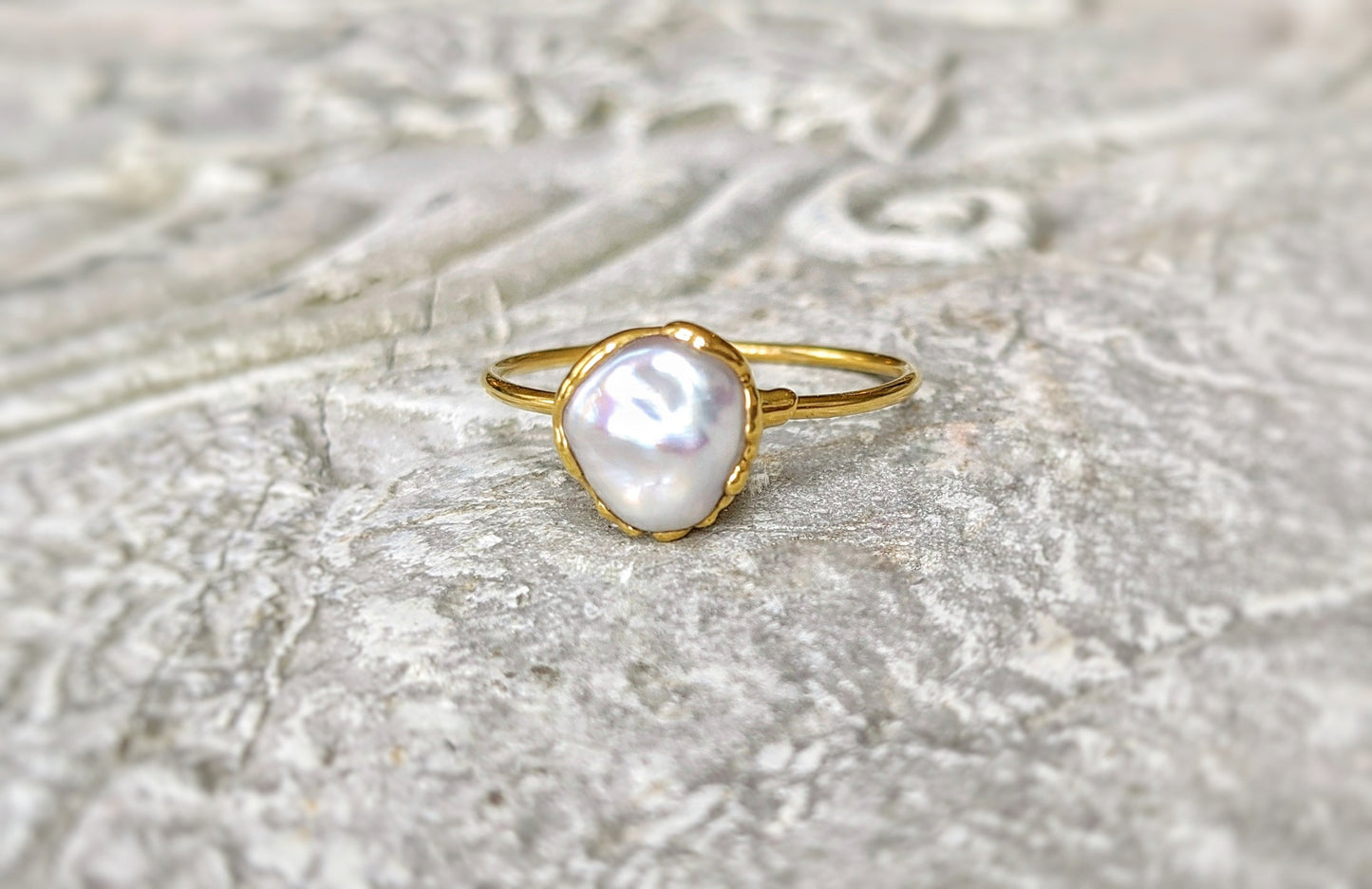 Handcrafted small Keshi pearl ring on a solid 14k gold band, showcasing elegance and simplicity.