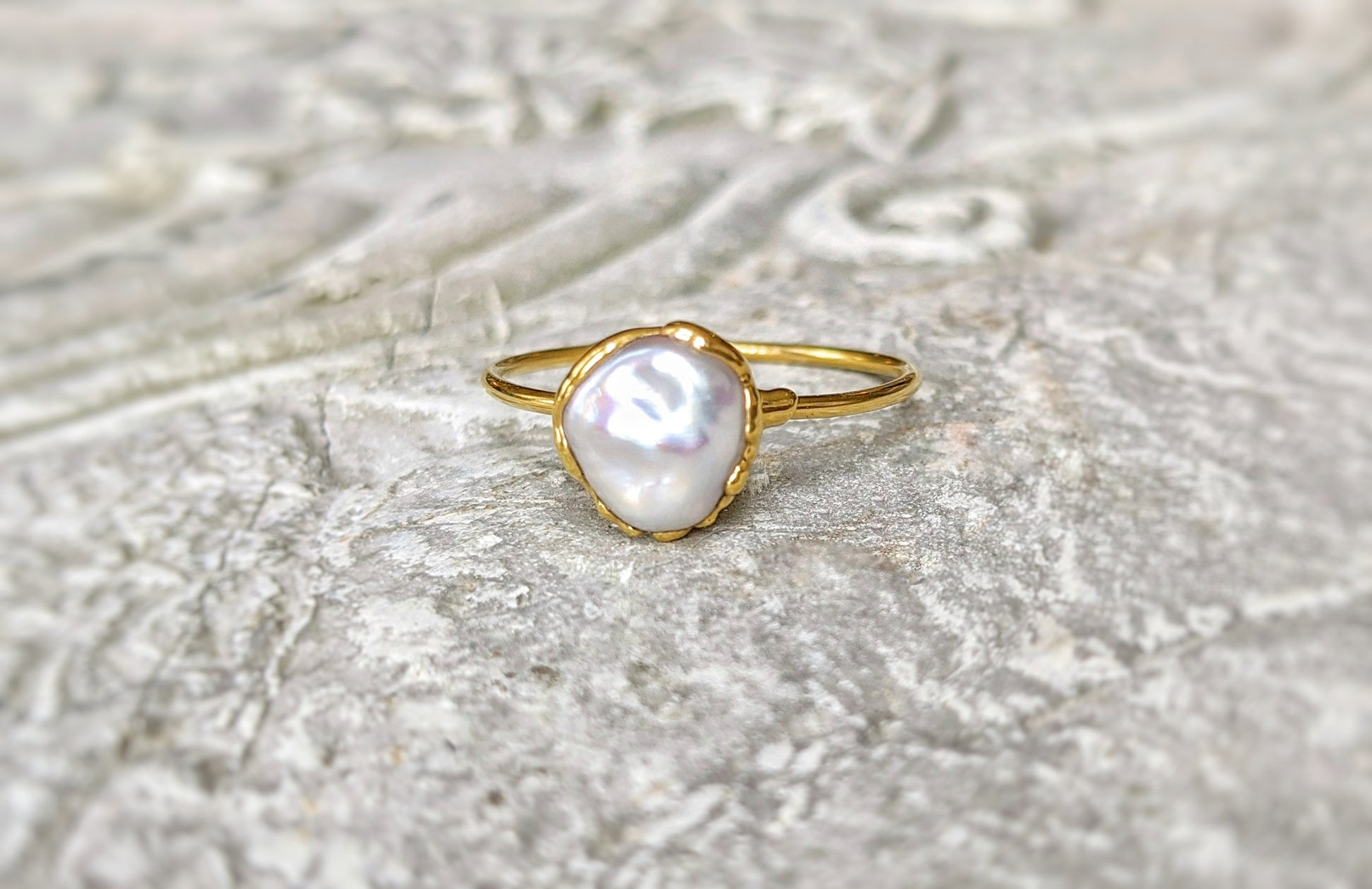 Handcrafted small Keshi pearl ring on a solid 14k gold band, showcasing elegance and simplicity.