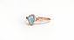 Raw Aquamarine Eternity ring on a rose gold band, showcasing rustic charm and natural beauty.