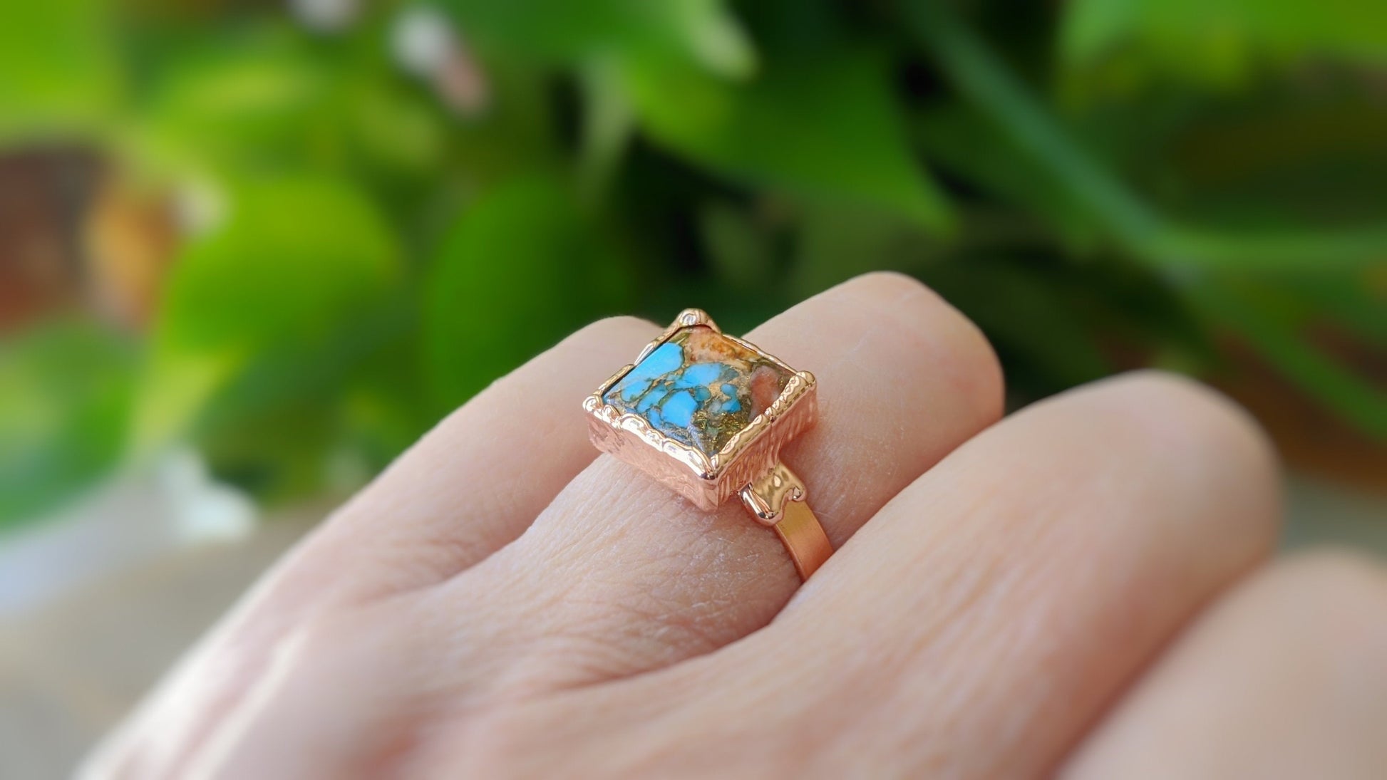 Pink Opal copper turquoise ring on a hand, showcasing a 10mm square gemstone on a 14k gold filled band.