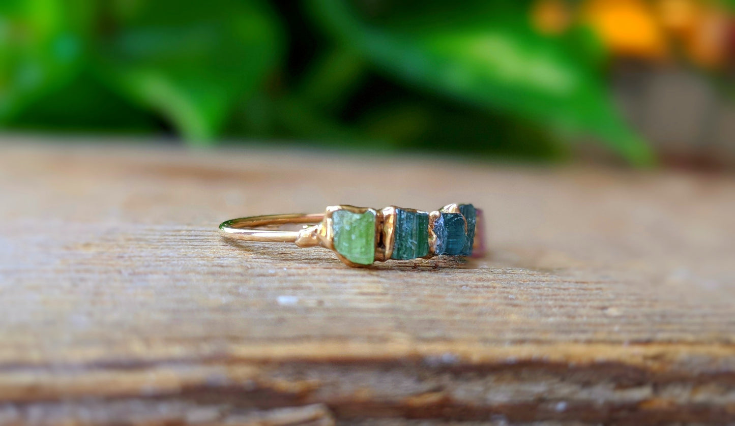 Raw Tourmaline eternity ring with five colorful stones on a 14k gold filled band, perfect for casual or formal wear.