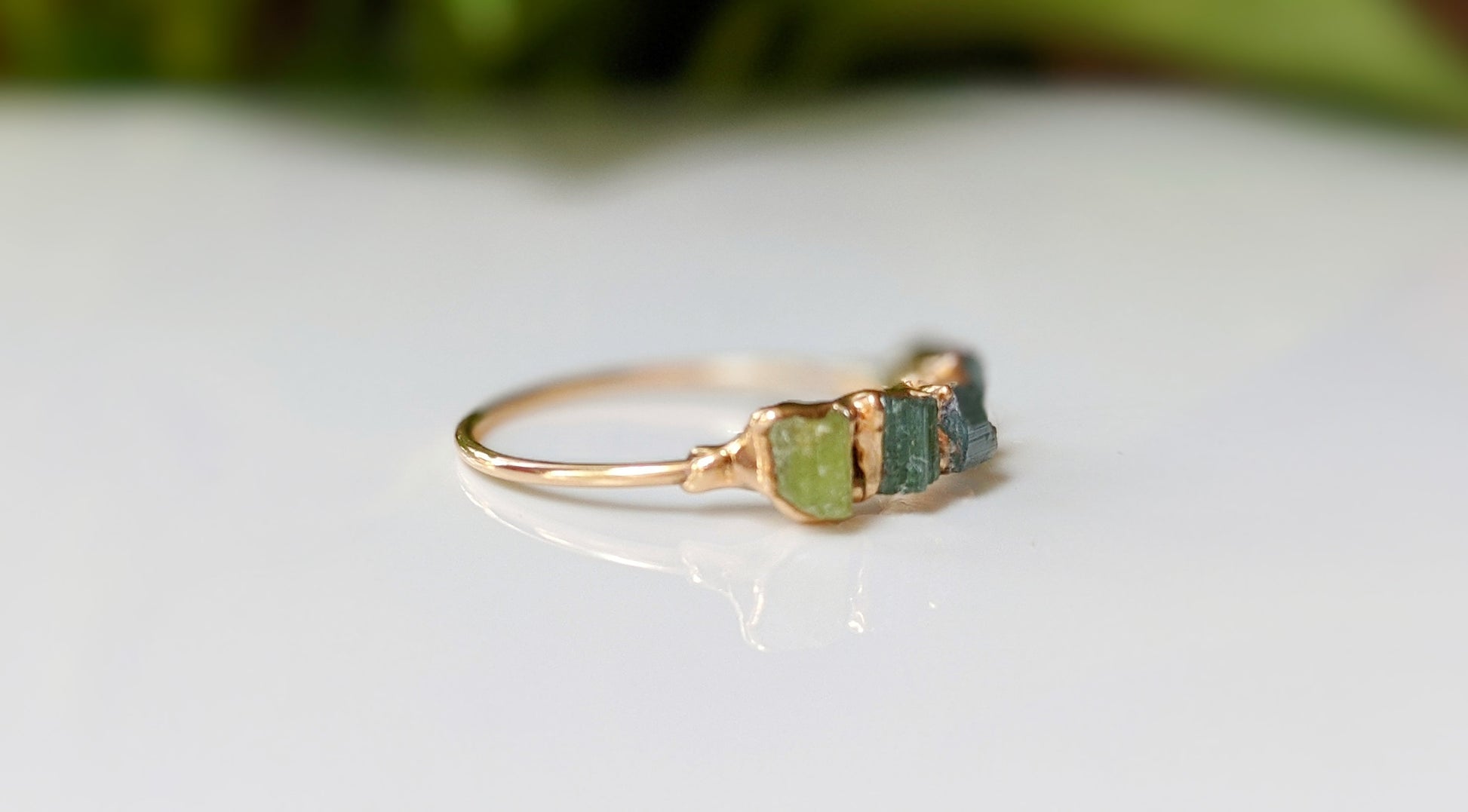 Elegant Raw Tourmaline eternity ring featuring colorful gemstones set on a gold-filled band.