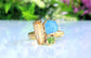 Raw Topaz, Aquamarine, and Peridot cluster ring on a gold band, perfect for summer outfits.