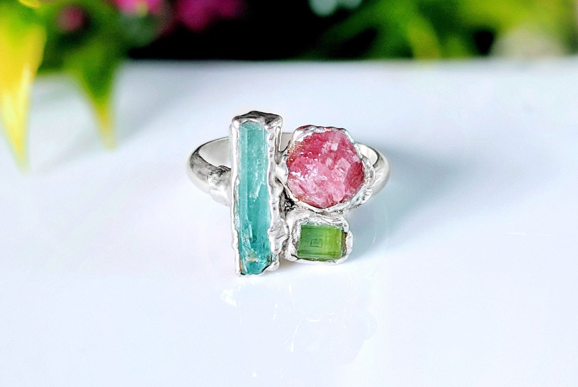 Raw Aquamarine, Tourmaline and Peridot cluster ring with a silver band, perfect summer jewelry.