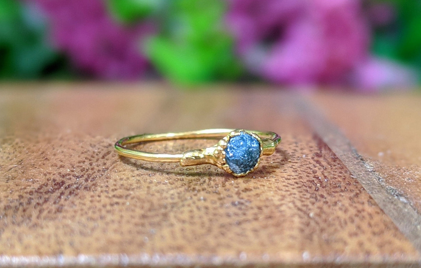 Raw blue diamond engagement ring set on solid 18k gold band, uniquely handcrafted for a special occasion.