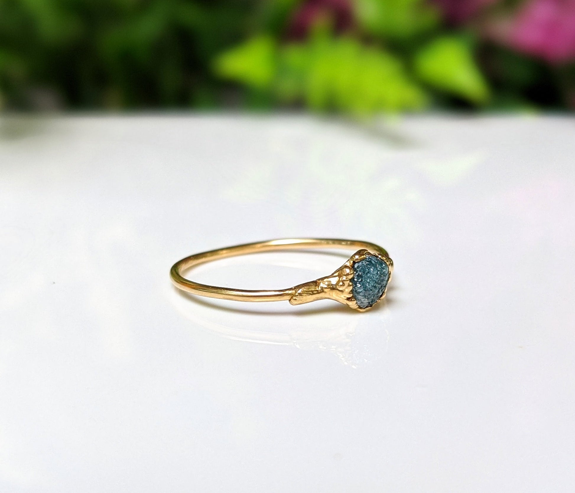 Handcrafted raw blue diamond engagement ring set on a solid 18k gold band, perfect for Valentine's Day.