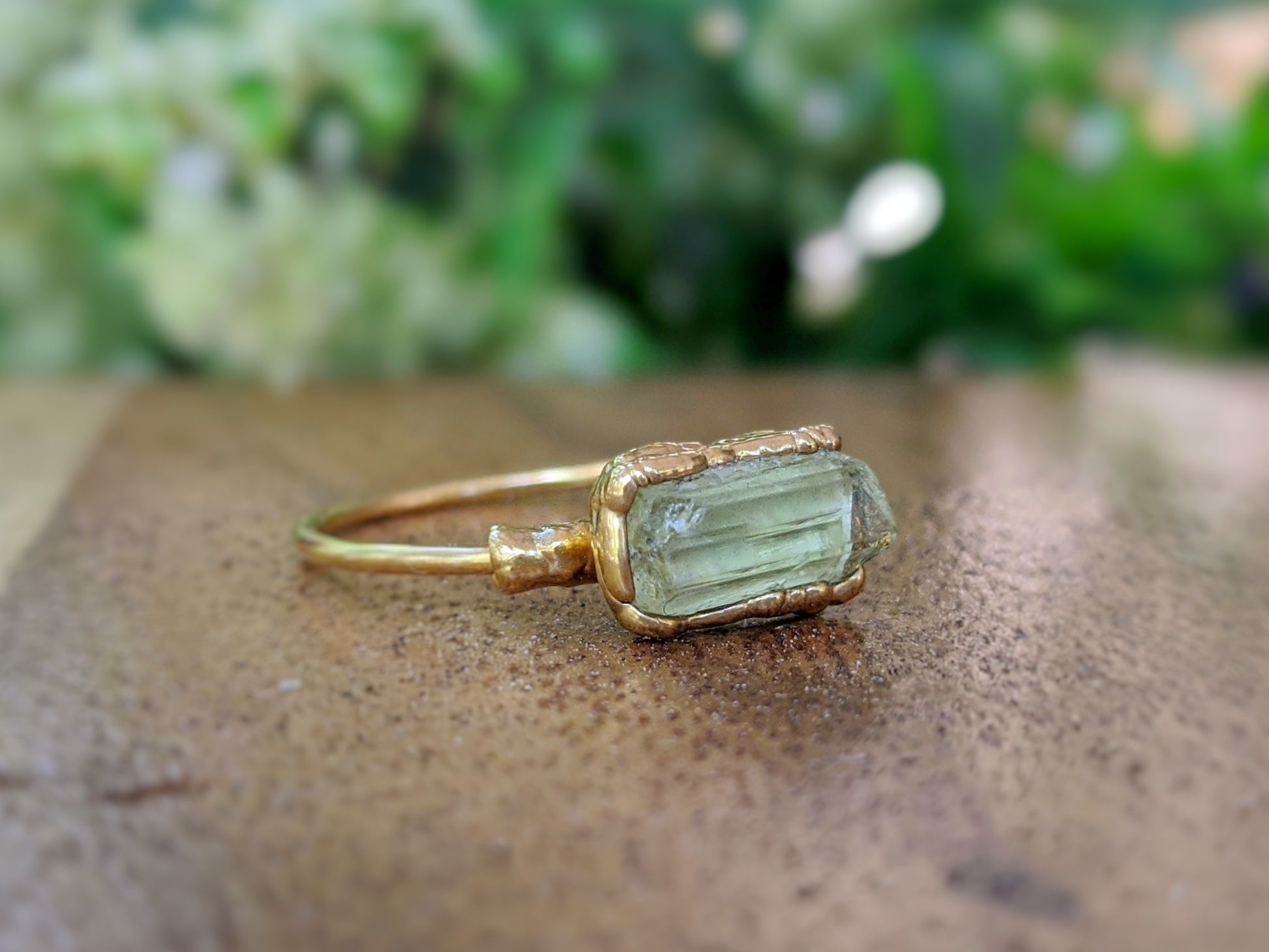 Raw yellow Apatite ring on a gold-filled band, featuring a unique electroformed bezel detail.
