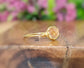 Raw Hessonite Garnet ring on a gold band, showcasing a natural gem with warm golden hues.