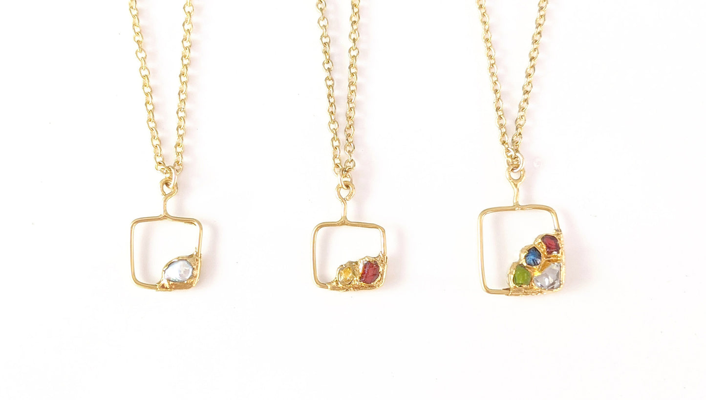 Family birthstone necklaces with square gold pendants and various raw gemstones, perfect for mothers.
