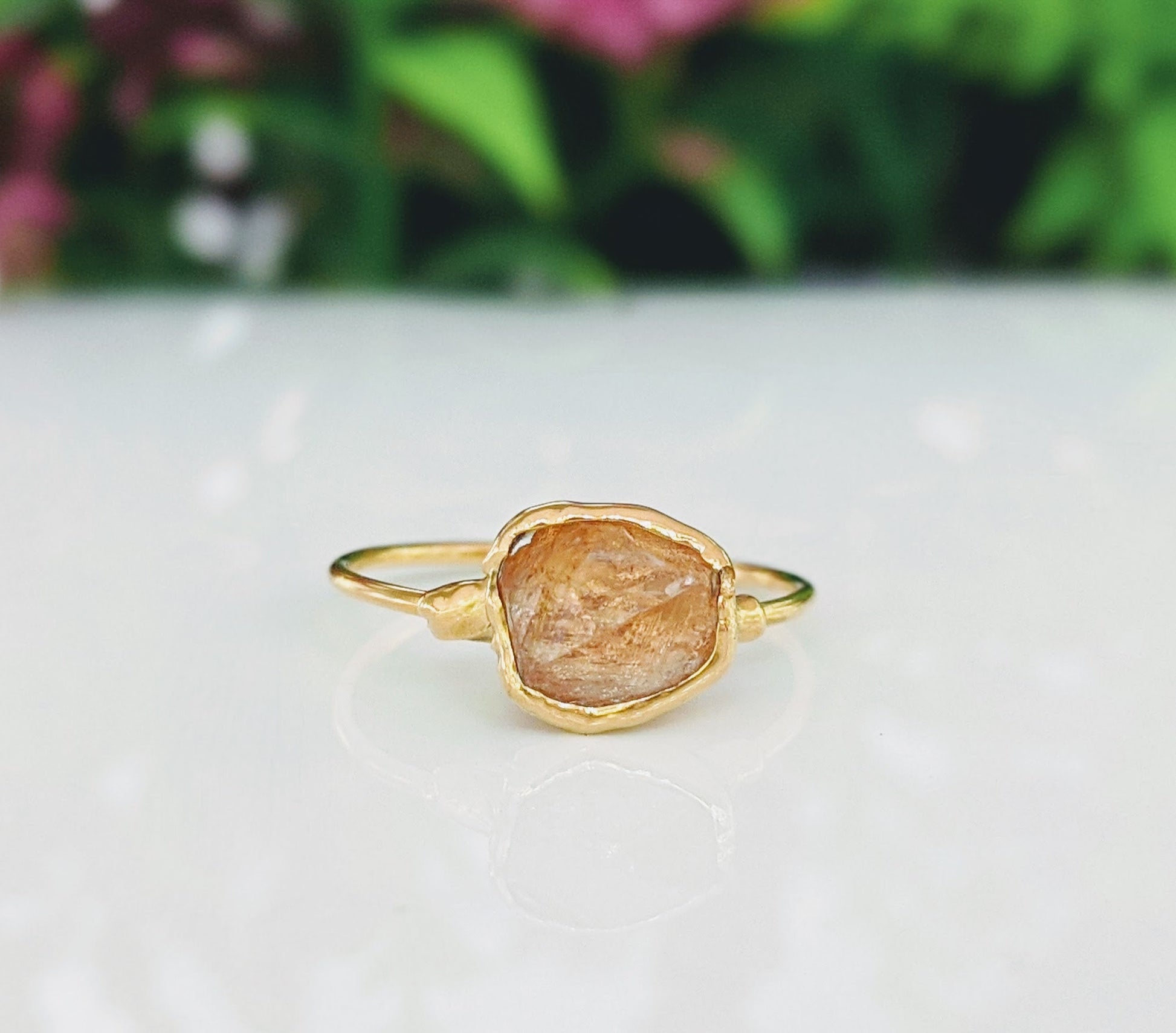 Raw Hessonite Garnet ring on a 14k Gold filled band, showcasing intricate natural textures and warm golden tones.