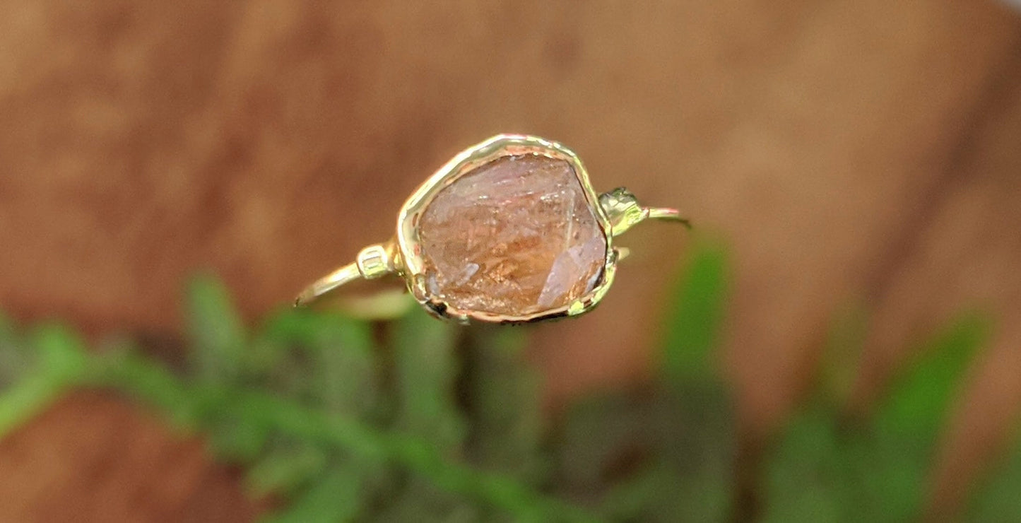Raw Hessonite Garnet ring set on a 14k Gold filled band, showcasing a unique golden gemstone.