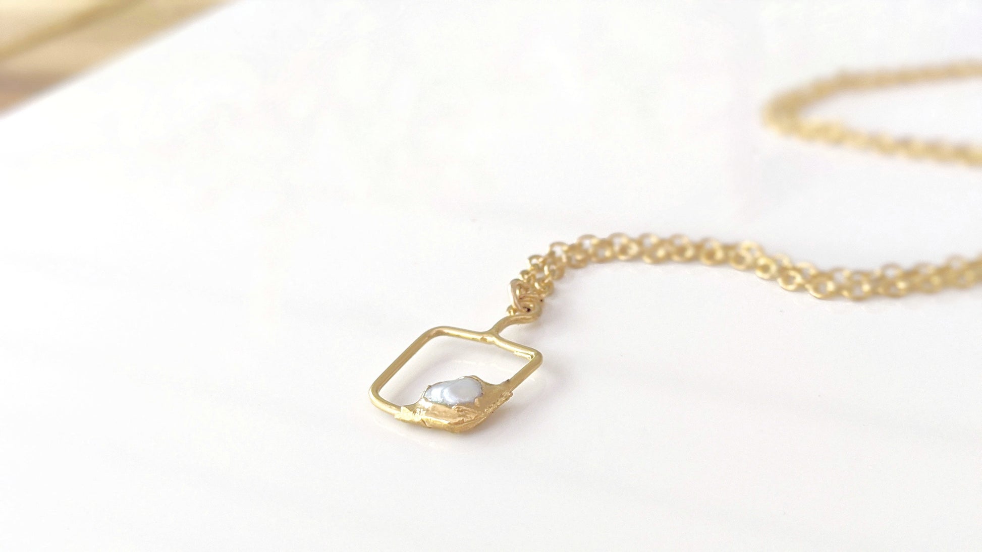 Gold filled necklace with a square pendant and raw gemstone, perfect for personalized gifting.