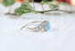 Raw Aquamarine and diamond twig ring on a white surface, highlighting its unique nature-inspired design.