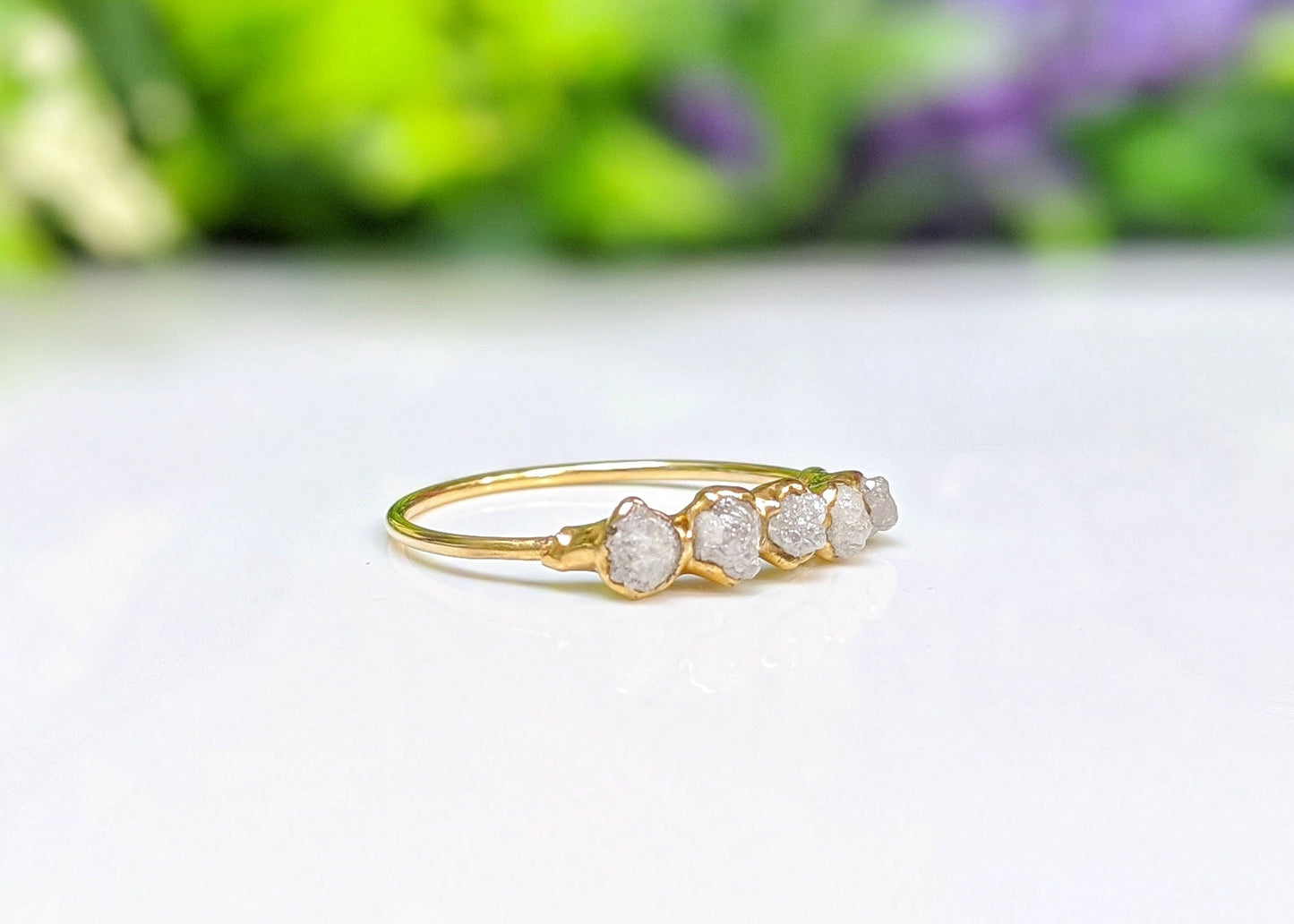 Handcrafted raw diamond eternity ring in 18k gold setting with five ethical diamonds, symbolizing everlasting love.