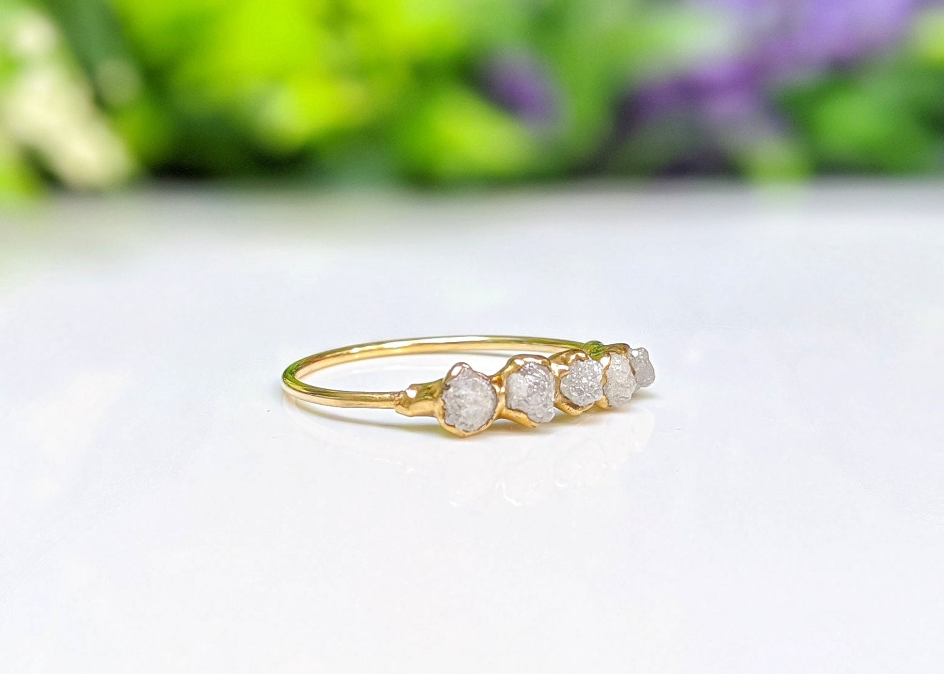 Handcrafted raw diamond eternity ring in 18k gold setting with five ethical diamonds, symbolizing everlasting love.