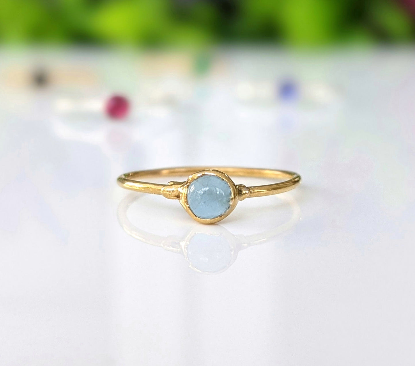 Dainty aquamarine stacking ring with a 4mm natural stone set on a gold-filled band, perfect for everyday wear.