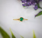 Dainty emerald stacking ring with a 4mm natural green emerald set on a gold-filled band, perfect for everyday wear.