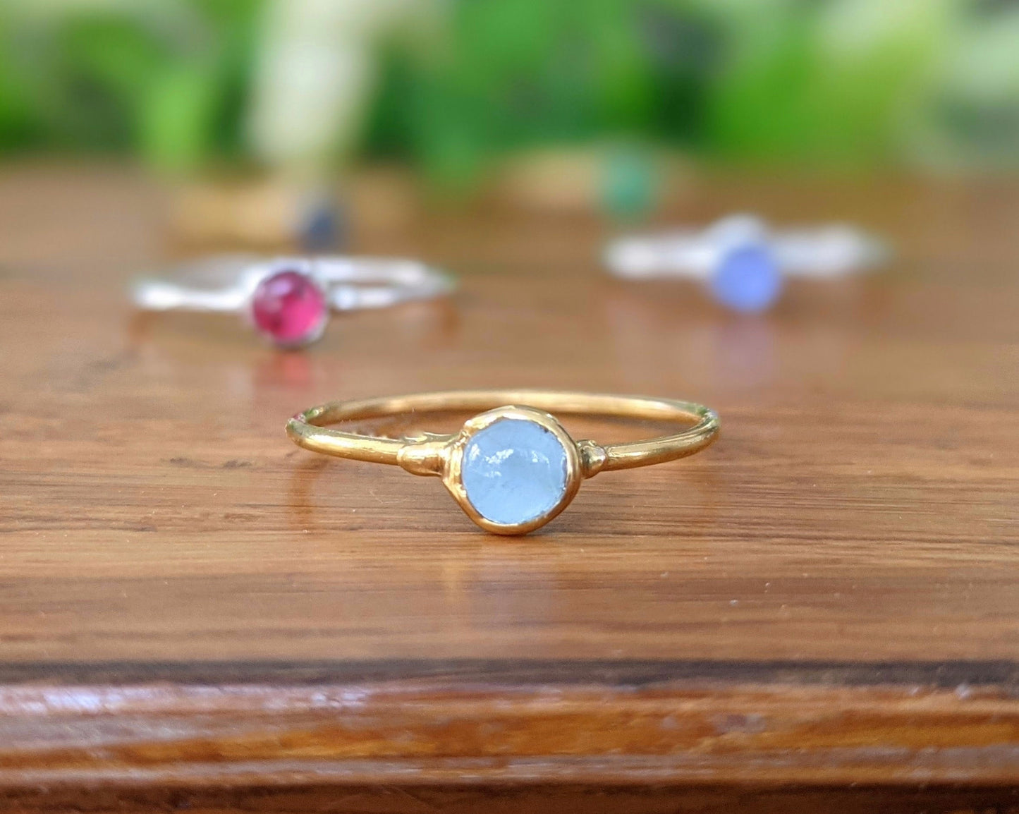 Dainty gold stacking ring featuring a natural aquamarine stone, perfect for minimalist jewelry lovers.
