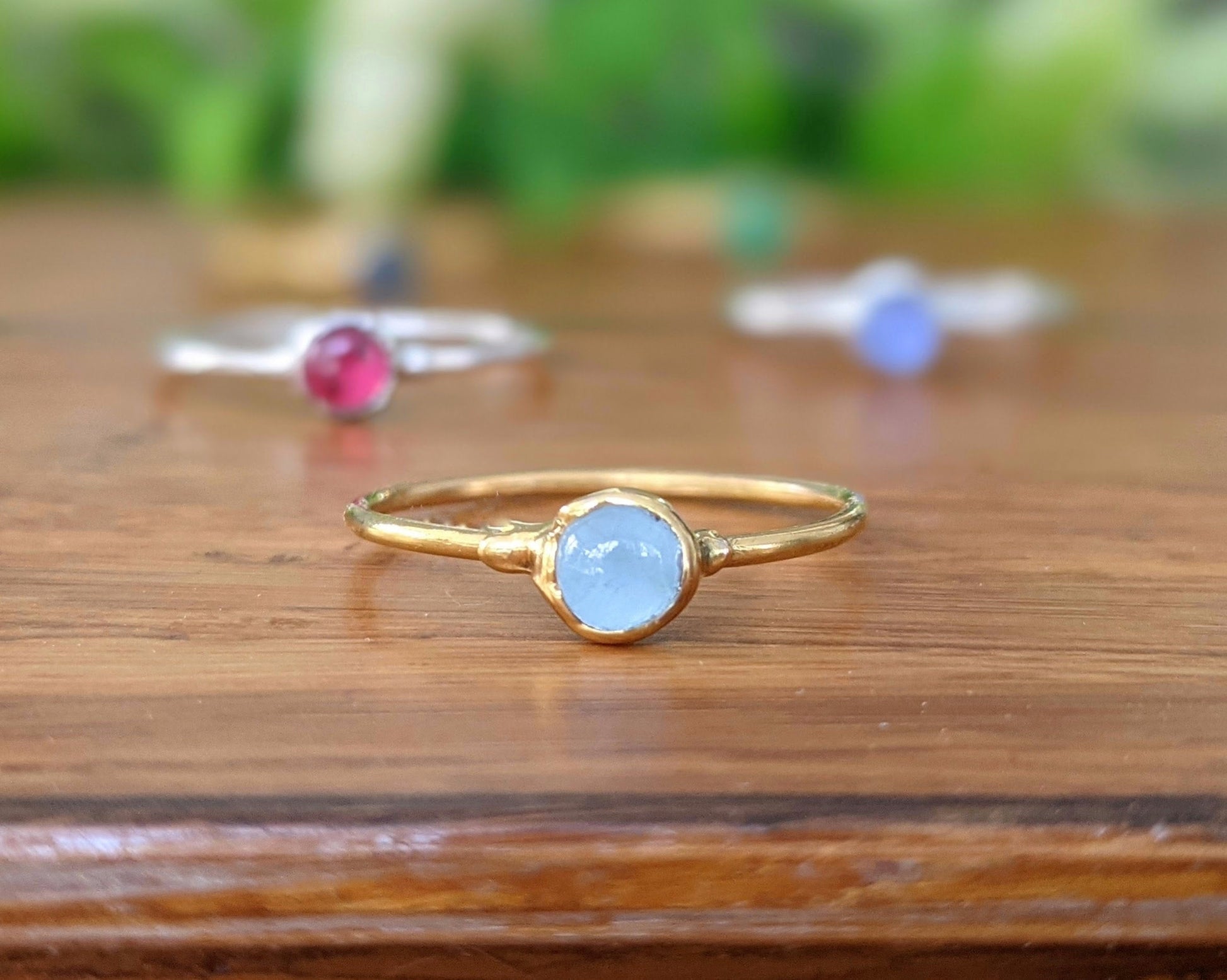 Dainty gold stacking ring featuring a natural aquamarine stone, perfect for minimalist jewelry lovers.