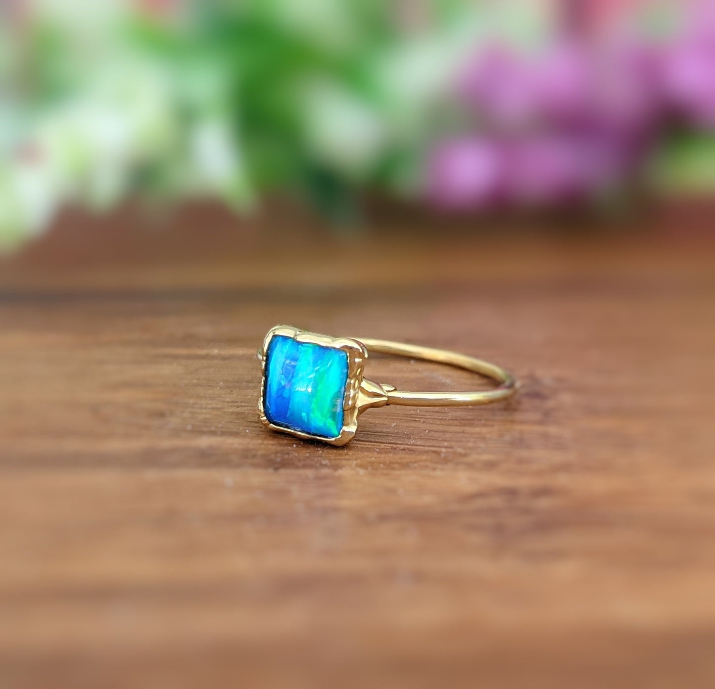 Aqua blue square cultured Opal ring set in a gold filled band, elegantly plated in 18k Gold, perfect for stylish accessories.