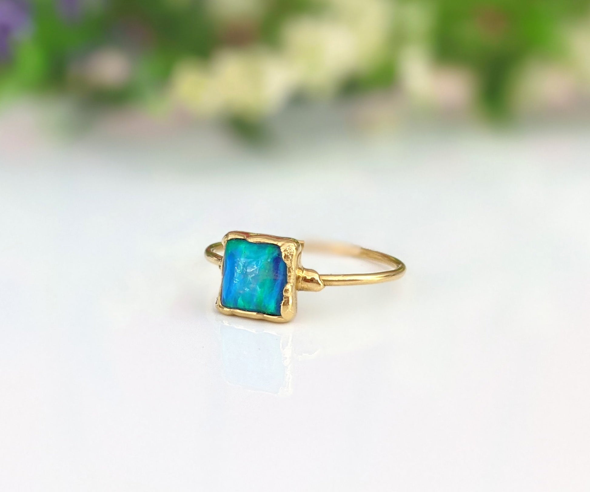 18k gold plated ring featuring a square aqua blue cultured Opal on a delicate band, handmade and unique.
