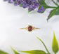 Dainty gold stacking ring featuring a small natural red Garnet gemstone, perfect for everyday wear or stacking.