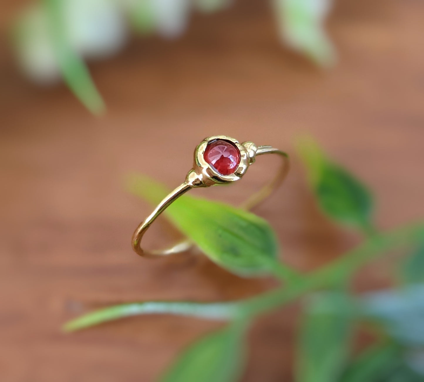 Dainty gold stacking ring featuring a 4mm natural red Garnet gemstone, perfect for everyday wear or Mother's ring sets.