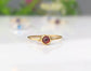 Dainty gold stacking ring featuring a natural red Garnet gemstone, perfect for minimalist jewelry lovers.
