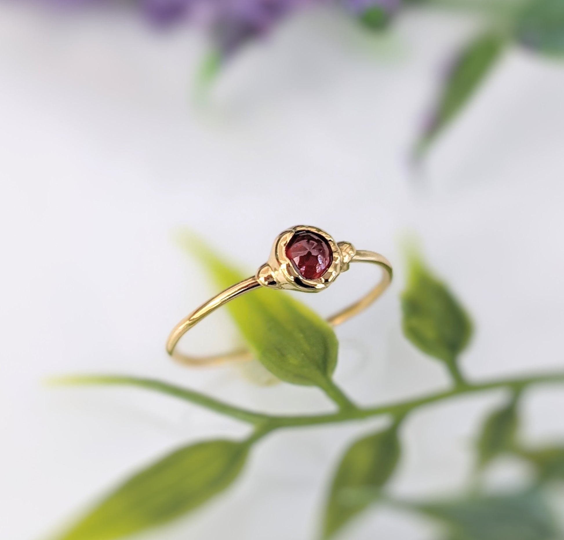 Dainty gold filled stacking ring featuring a natural red Garnet gemstone, ideal for January birthdays and everyday wear.