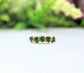 Handcrafted raw emerald multi-stone ring on a gold band, featuring 5 unique emeralds, perfect for May birthdays.