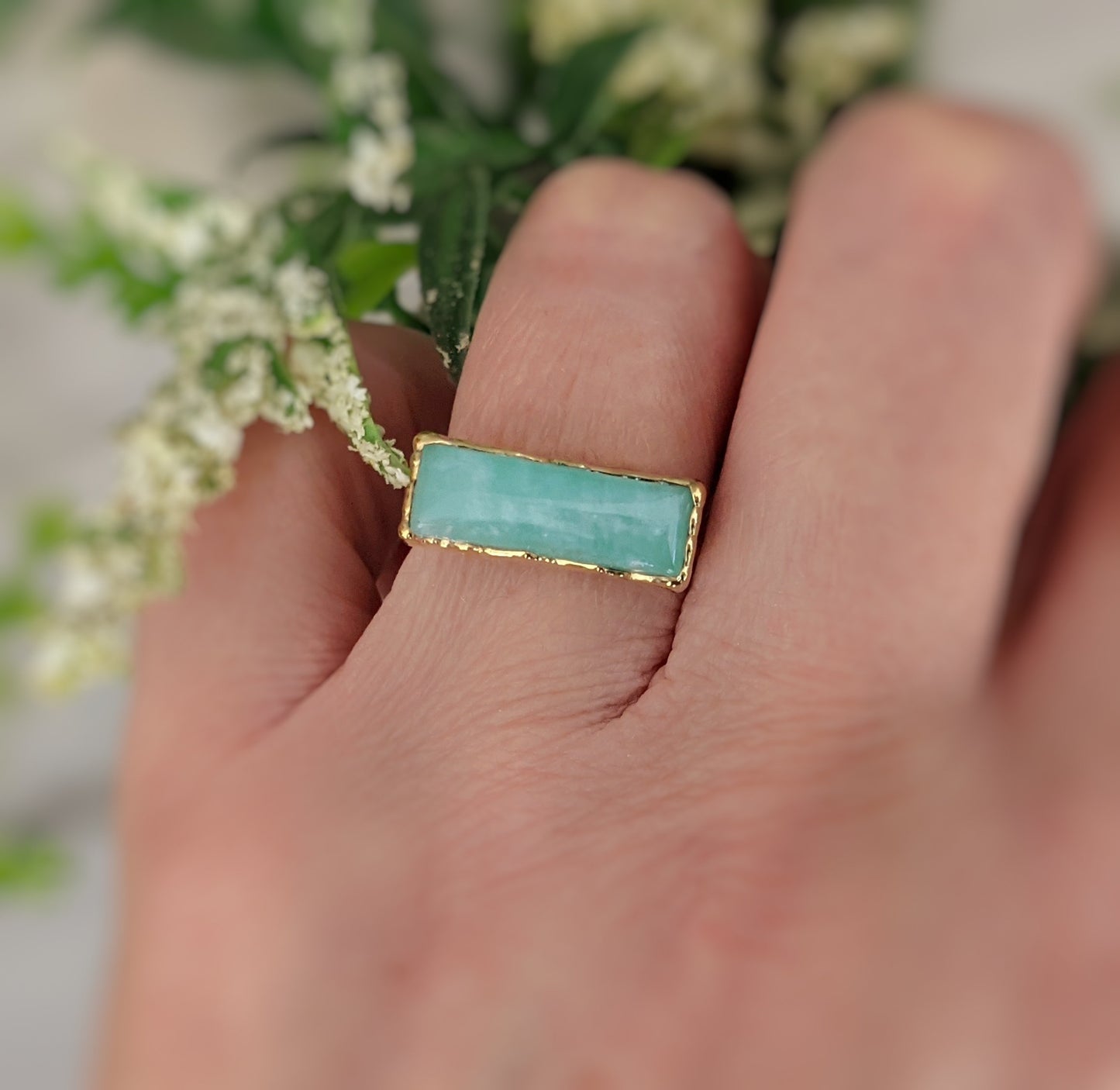 Amazonite gold bar ring on finger, featuring a 6x18mm natural stone on a 14k gold-filled band.