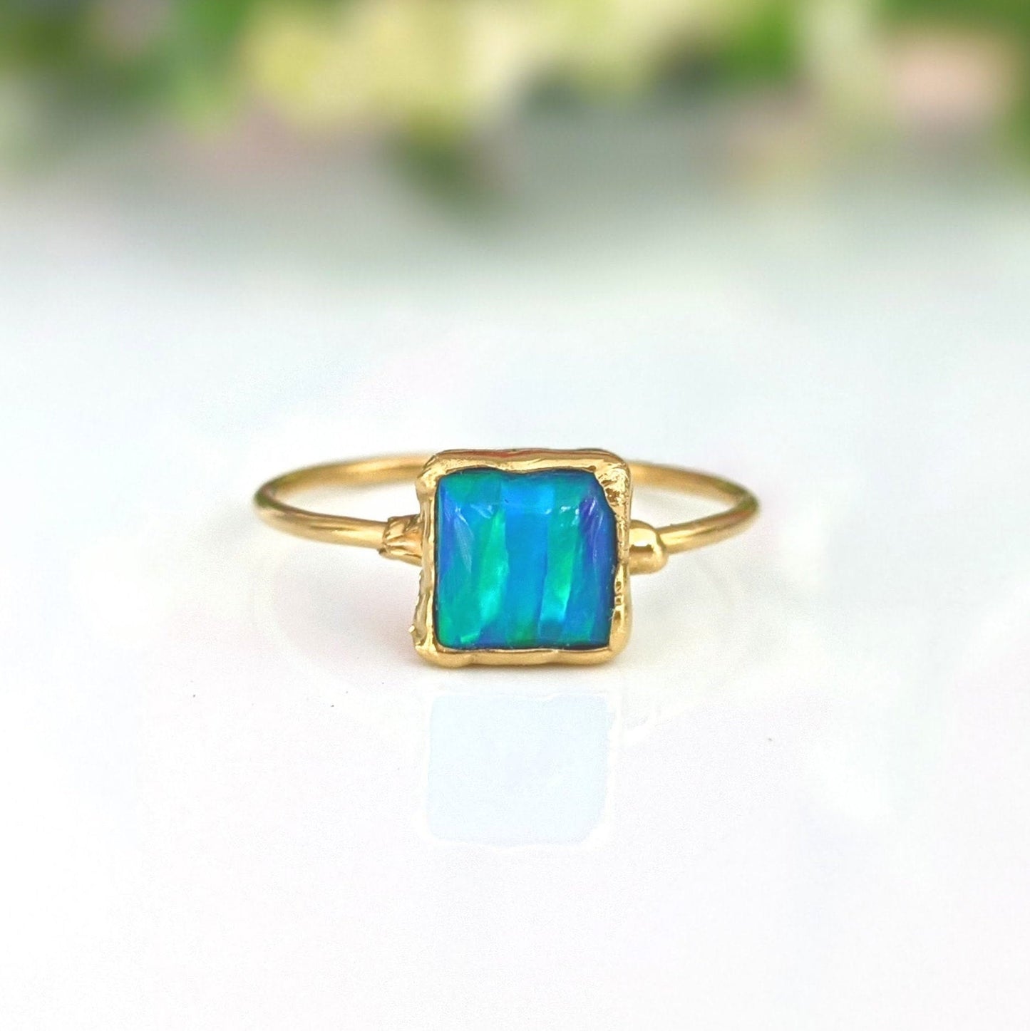 Blue Opal ring in 18k Gold with aqua blue square cultured Opal on a delicate band.